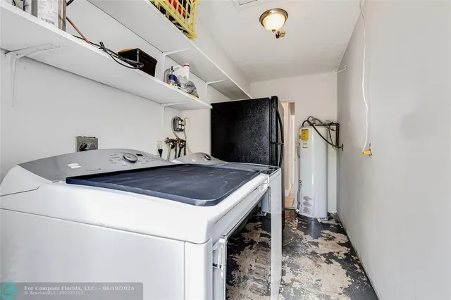 a kitchen with a sink a refrigerator and a stove