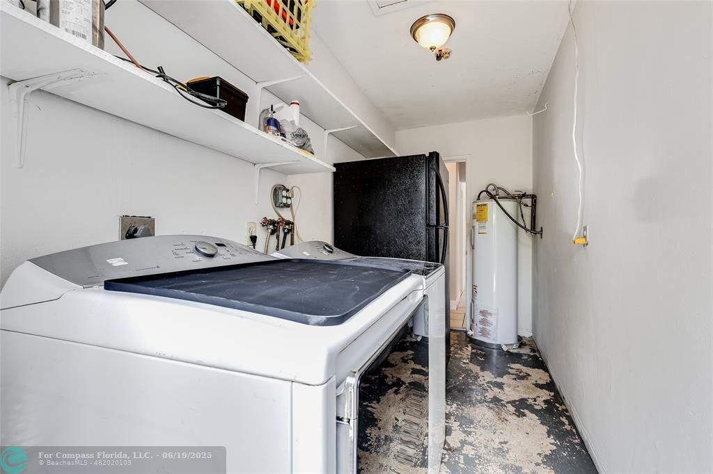 3460 Northeast 28th Avenue Lighthouse Point, FL 33064 - Photo 18 of 37 a kitchen with a sink a refrigerator and a stove