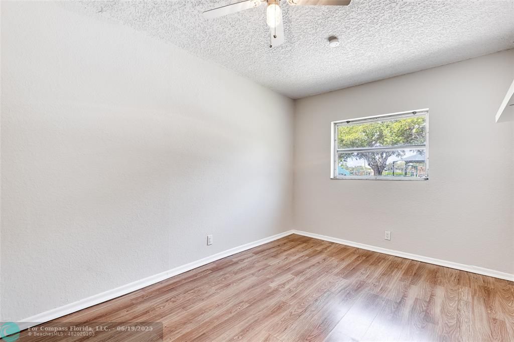 3460 Northeast 28th Avenue Lighthouse Point, FL 33064 - Photo 19 of 37 an empty room with wooden floor and windows