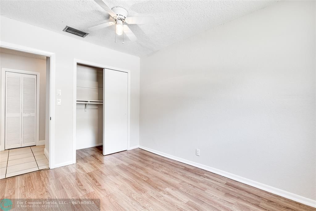 3460 Northeast 28th Avenue Lighthouse Point, FL 33064 - Photo 21 of 37 a view of empty room with wooden floor and ceiling fan