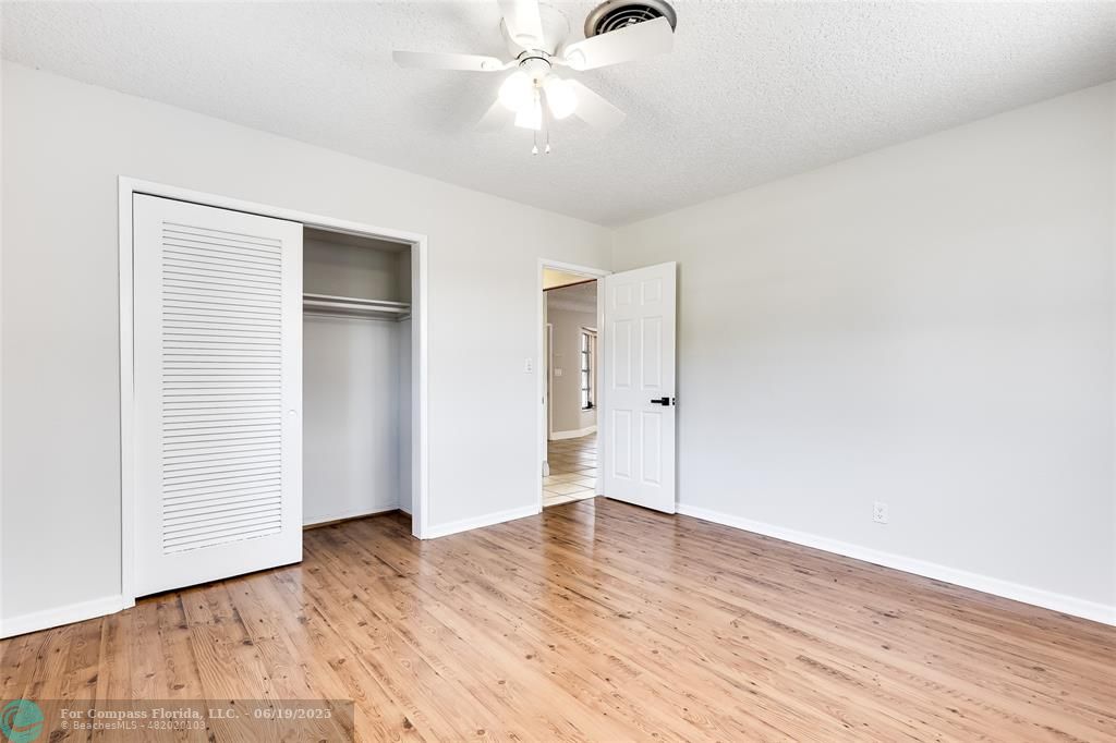 3460 Northeast 28th Avenue Lighthouse Point, FL 33064 - Photo 26 of 37 an empty room with wooden floor closet and windows