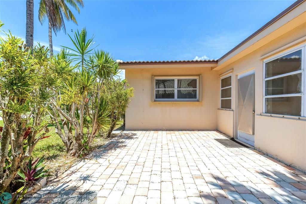 3460 Northeast 28th Avenue Lighthouse Point, FL 33064 - Photo 32 of 37 a view of a house with a yard