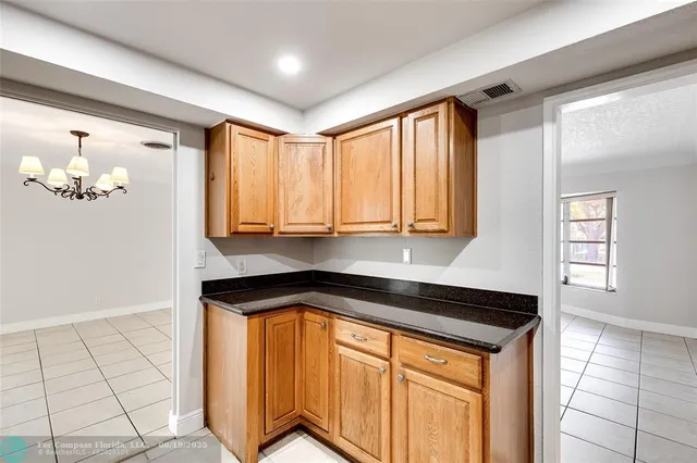 a kitchen with granite countertop a sink and a stove top oven