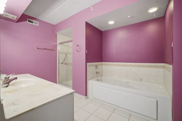 a bathroom with a bathtub sink and a mirror