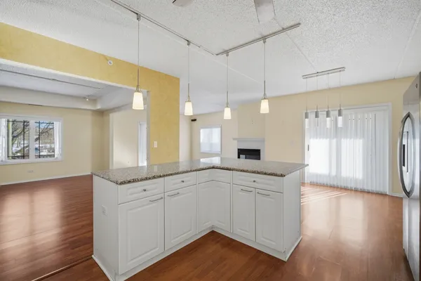 a kitchen with a sink cabinets and wooden floor
