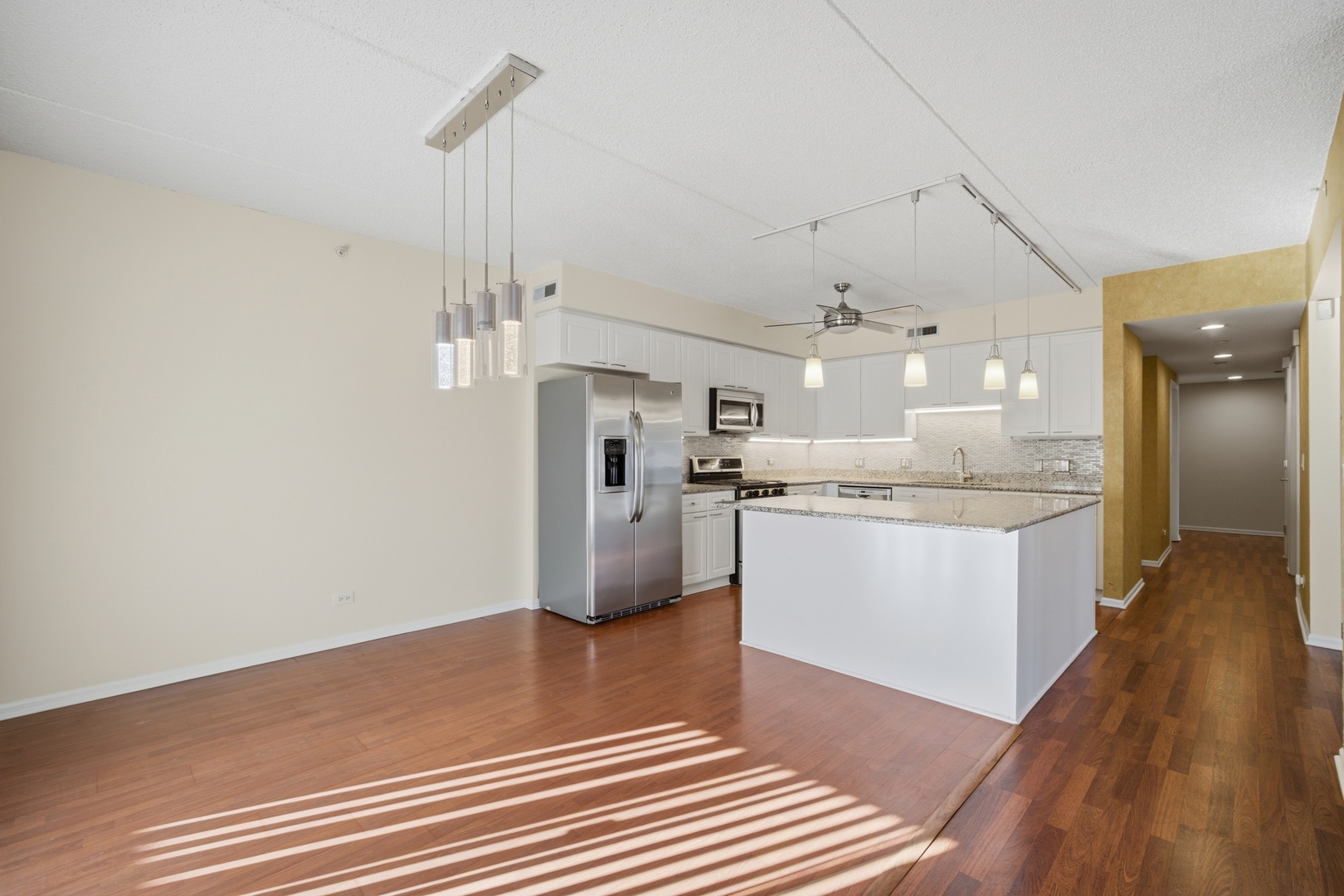 115 North Clifton Avenue, Unit 103 Park Ridge, IL 60068 - Photo 9 of 27 a kitchen with kitchen island white cabinets and stainless steel appliances