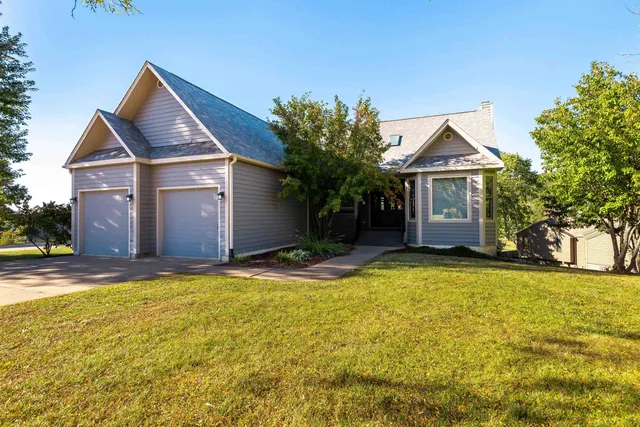 a front view of a house with yard and garage