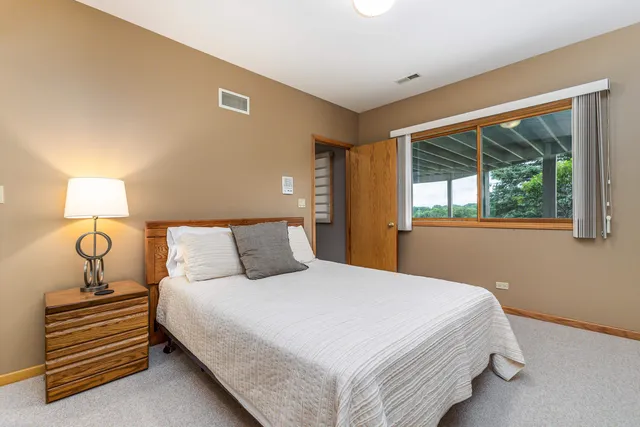 a bedroom with a bed and window