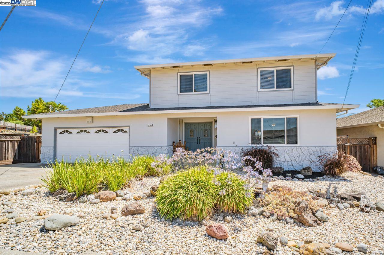 a front view of a house with a yard outdoor seating and covered with furniture
