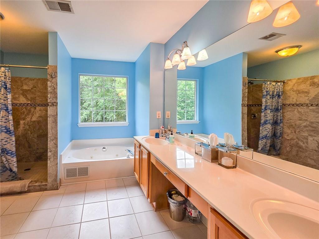 43 Ivy Mist Lane Acworth, GA 30101 - Photo 18 of 58 a bathroom with a tub sink and a mirror