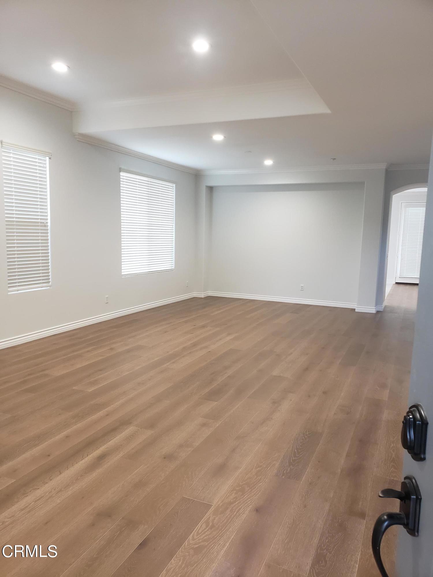 7454 Chanteclair Court Tujunga, CA 91042 - Photo 2 of 25 an empty room with wooden floor and windows