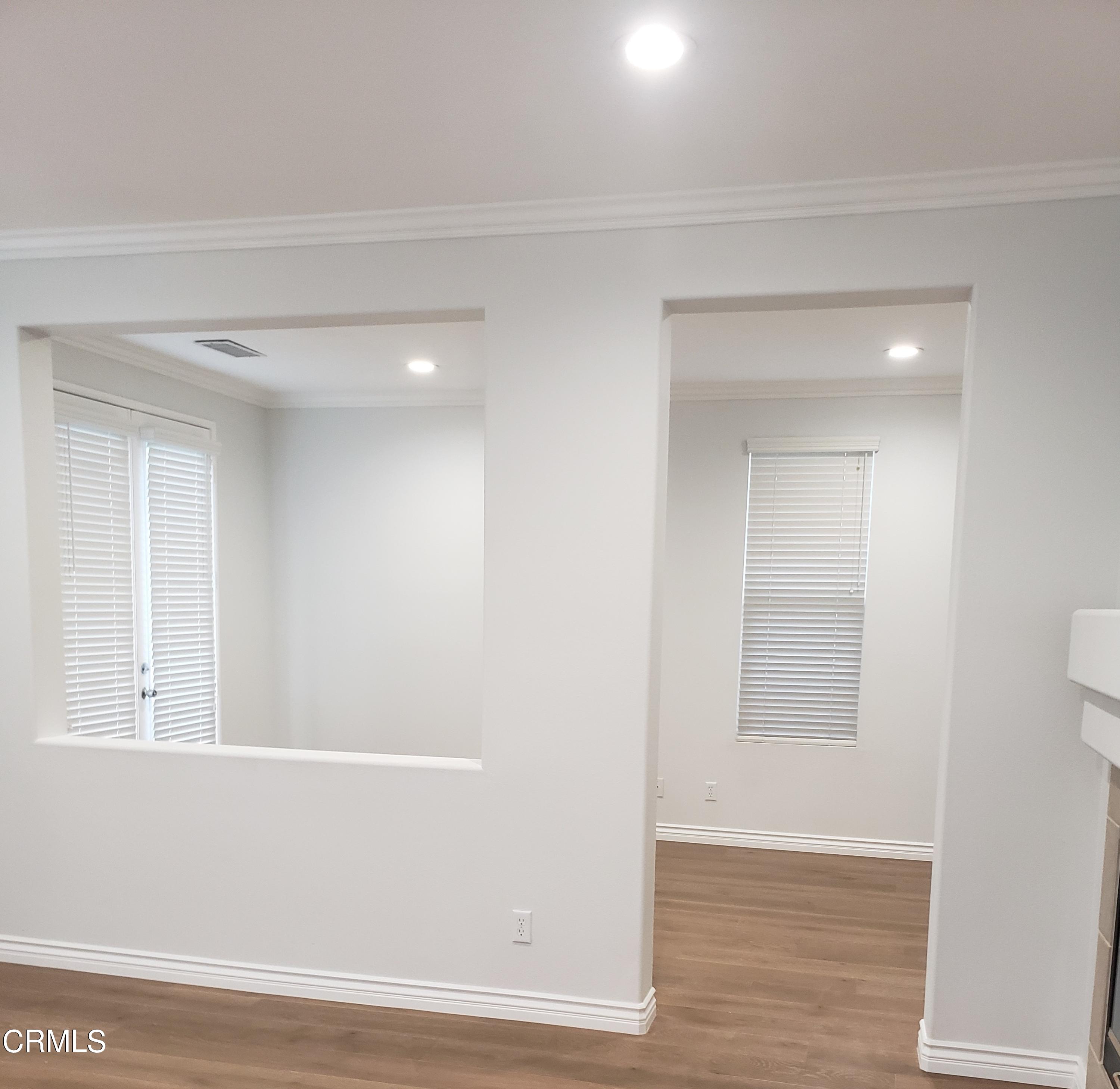 7454 Chanteclair Court Tujunga, CA 91042 - Photo 11 of 25 a view of an empty room with wooden floor and a window