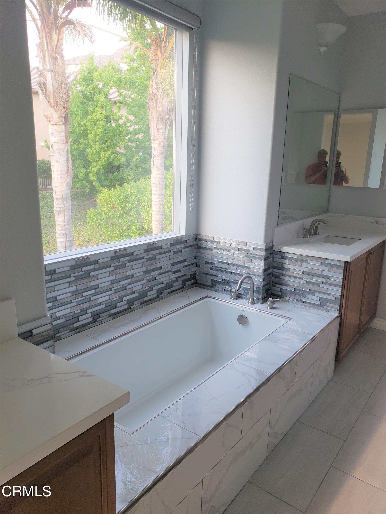 7454 Chanteclair Court Tujunga, CA 91042 - Photo 15 of 25 a bathroom with a granite countertop sink and mirror