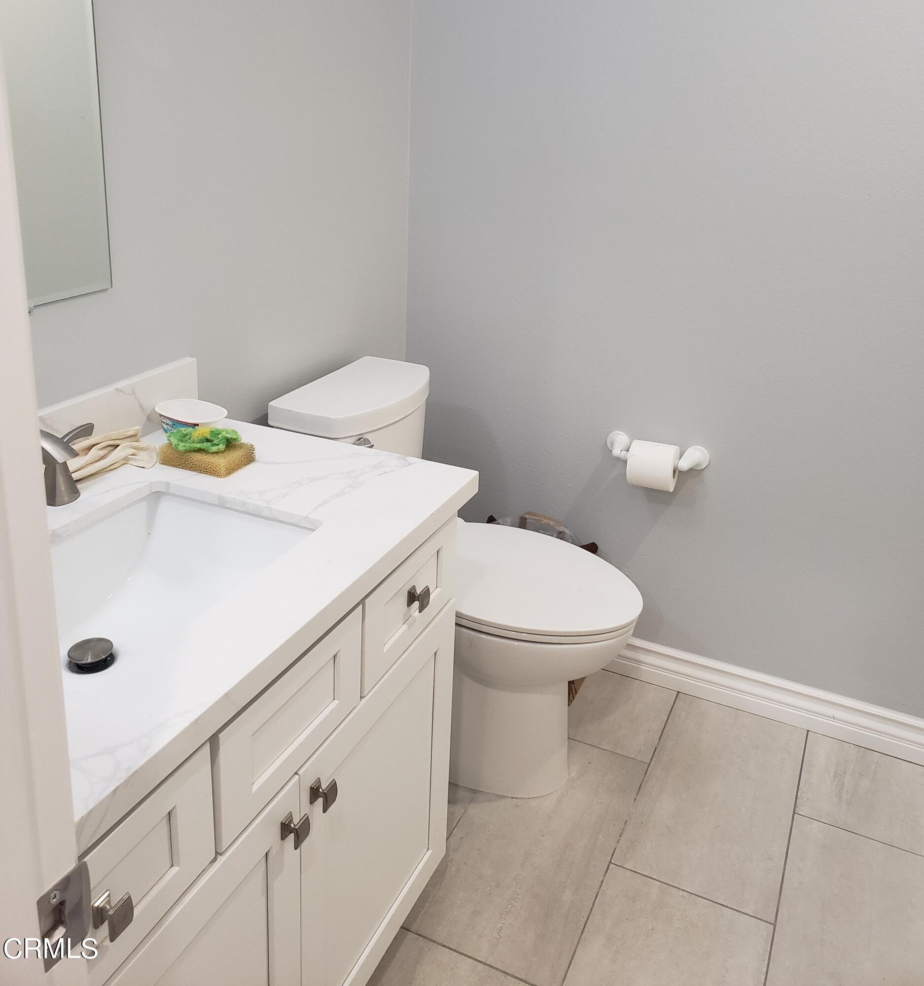 7454 Chanteclair Court Tujunga, CA 91042 - Photo 22 of 25 a bathroom with a sink a toilet and a mirror