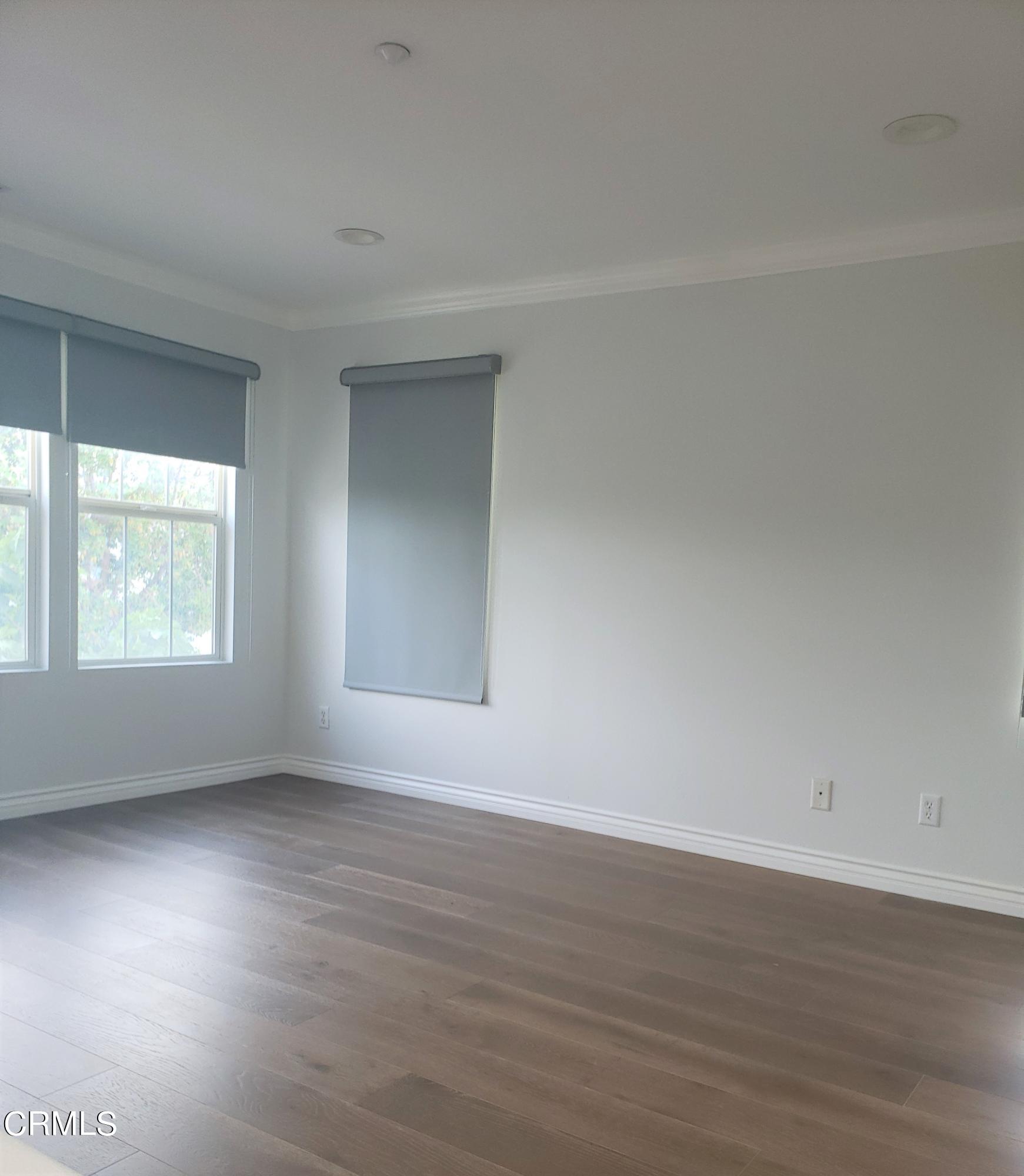 7454 Chanteclair Court Tujunga, CA 91042 - Photo 24 of 25 a view of an empty room with wooden floor and a window