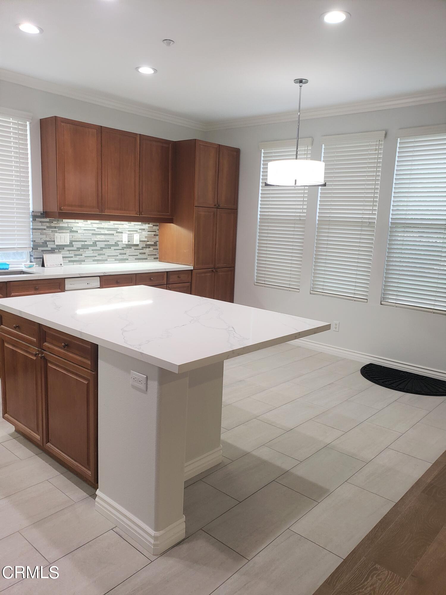 7454 Chanteclair Court Tujunga, CA 91042 - Photo 4 of 25 a kitchen with a sink cabinets and window