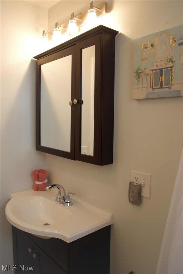 4233 Ellison Road South Euclid, OH 44121 - Photo 10 of 30 Downstairs Bathroom Sink and Mirror