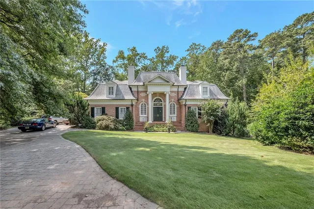 a front view of a house with a garden
