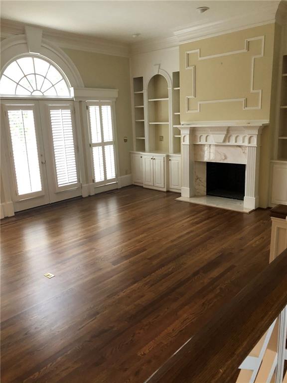 3184 Andrews Court Northwest Atlanta, GA 30305 - Photo 12 of 60 an empty room with wooden floor fireplace and windows