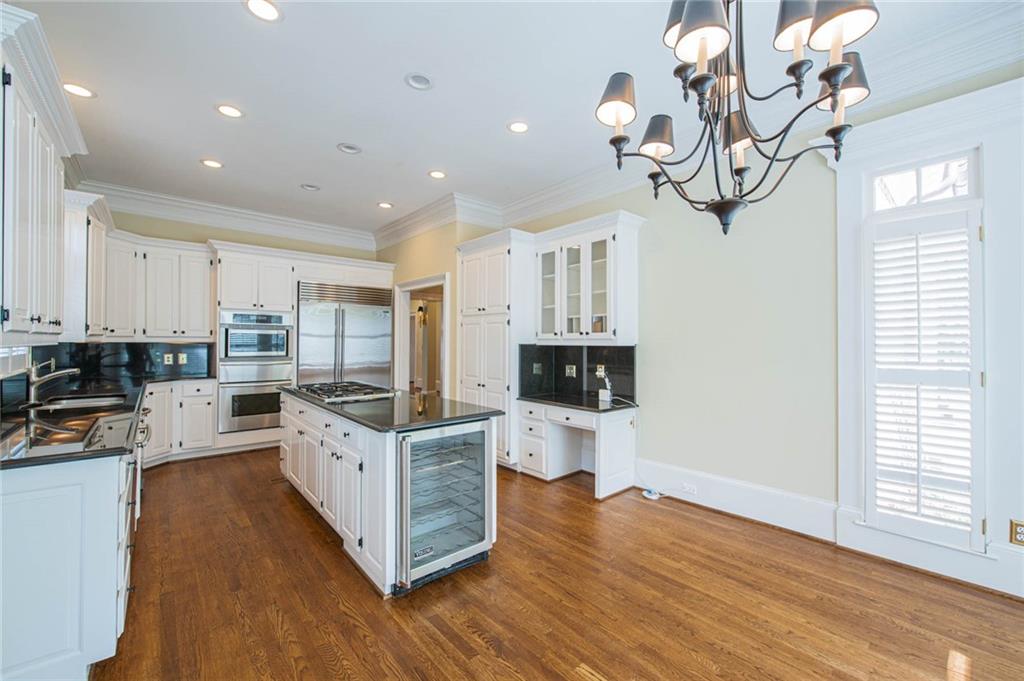 3184 Andrews Court Northwest Atlanta, GA 30305 - Photo 14 of 60 a kitchen with kitchen island granite countertop a sink cabinets and wooden floor