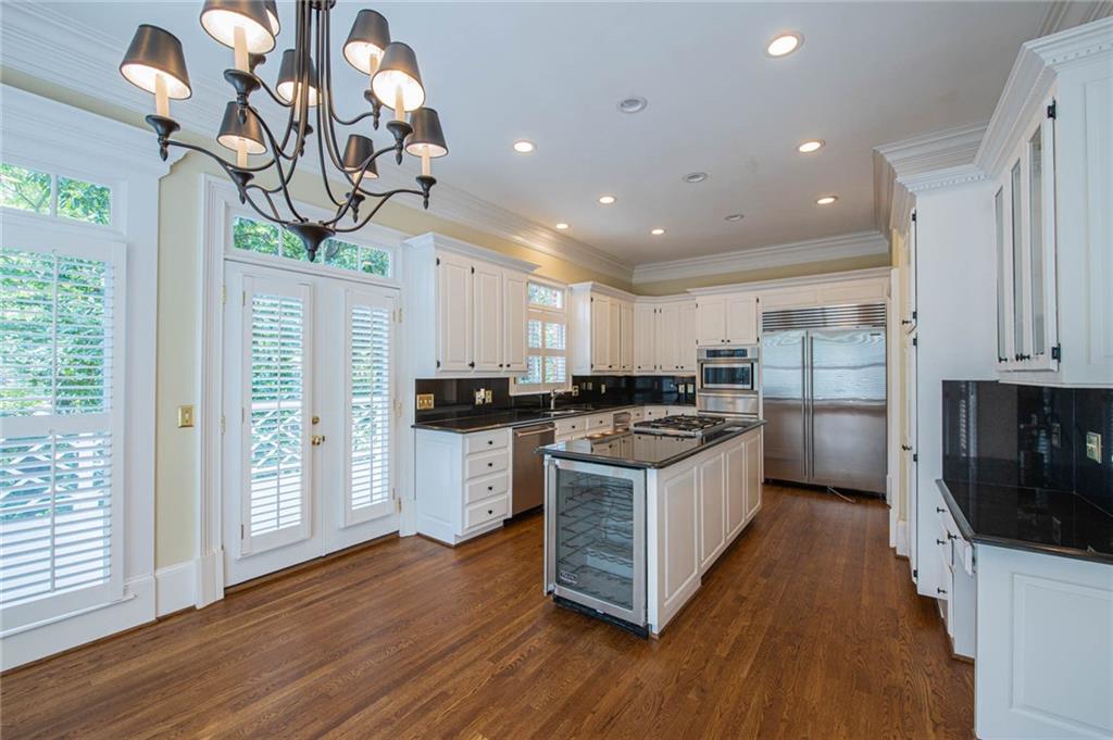 3184 Andrews Court Northwest Atlanta, GA 30305 - Photo 16 of 60 a kitchen with stainless steel appliances granite countertop a sink a stove and a wooden floors