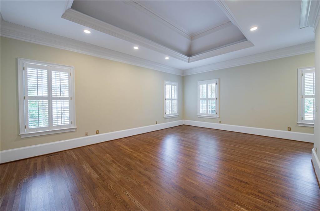 3184 Andrews Court Northwest Atlanta, GA 30305 - Photo 20 of 60 an empty room with wooden floor and windows with curtains view