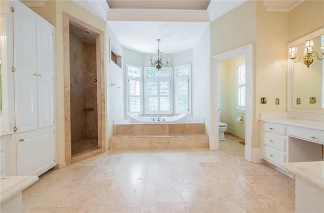 a spacious bathroom with a tub sink and mirror