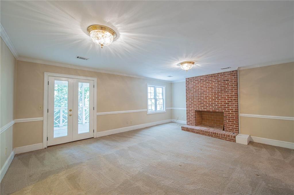 3184 Andrews Court Northwest Atlanta, GA 30305 - Photo 36 of 60 an empty room with windows fireplace and fans