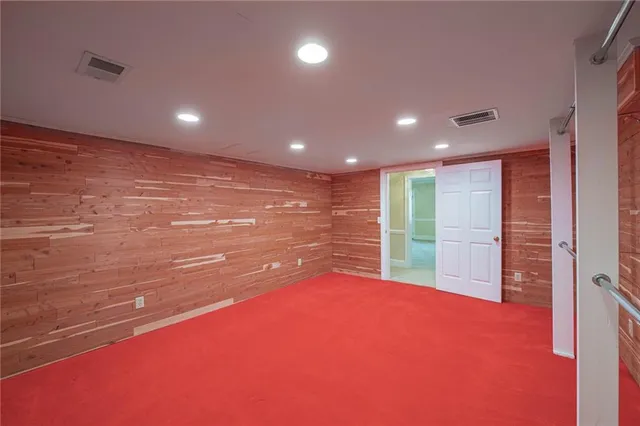 an empty room with windows and closet