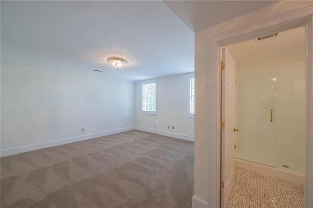 a room with pool table and windows