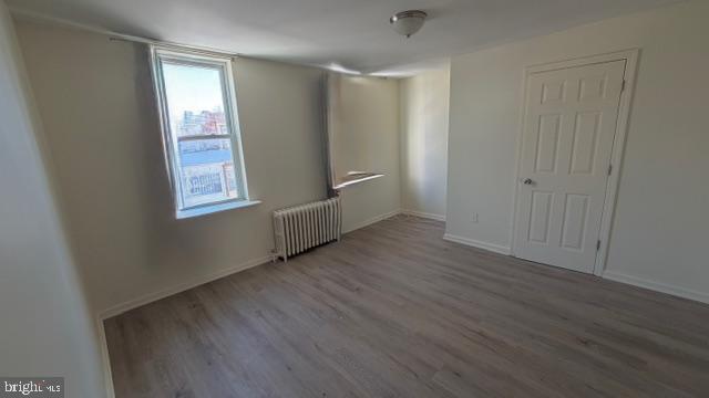231 3rd Street Gloucester City, NJ 08030 - Photo 13 of 23 an empty room with wooden floor and windows