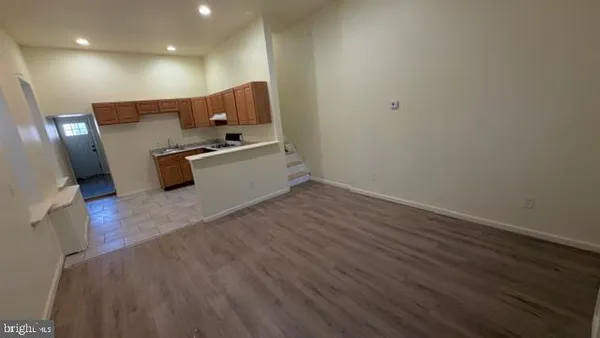 a view of a room with wooden floor