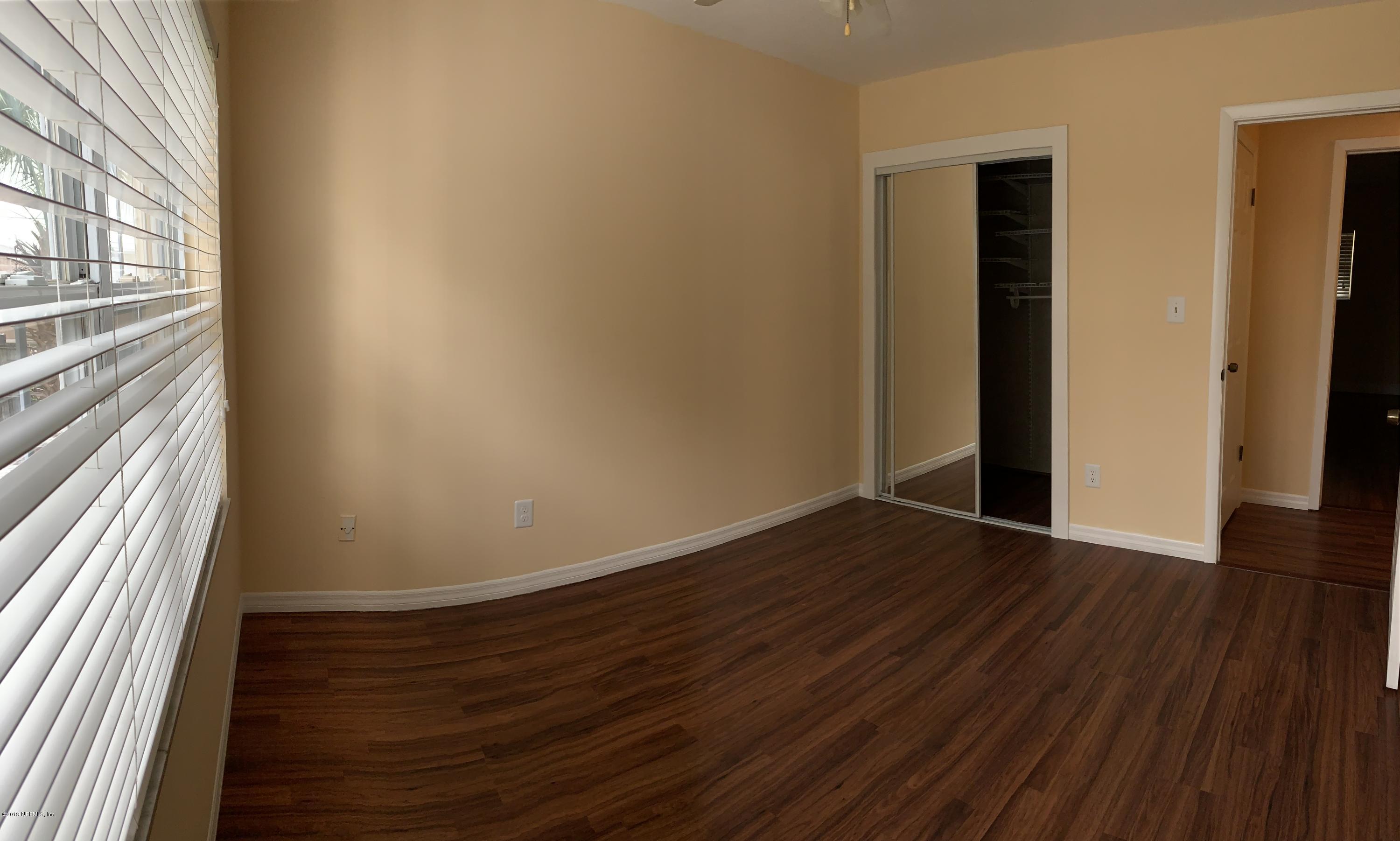 6108 Tuscony Circle Jacksonville, FL 32277 - Photo 8 of 9 a view of a room with wooden floor and window