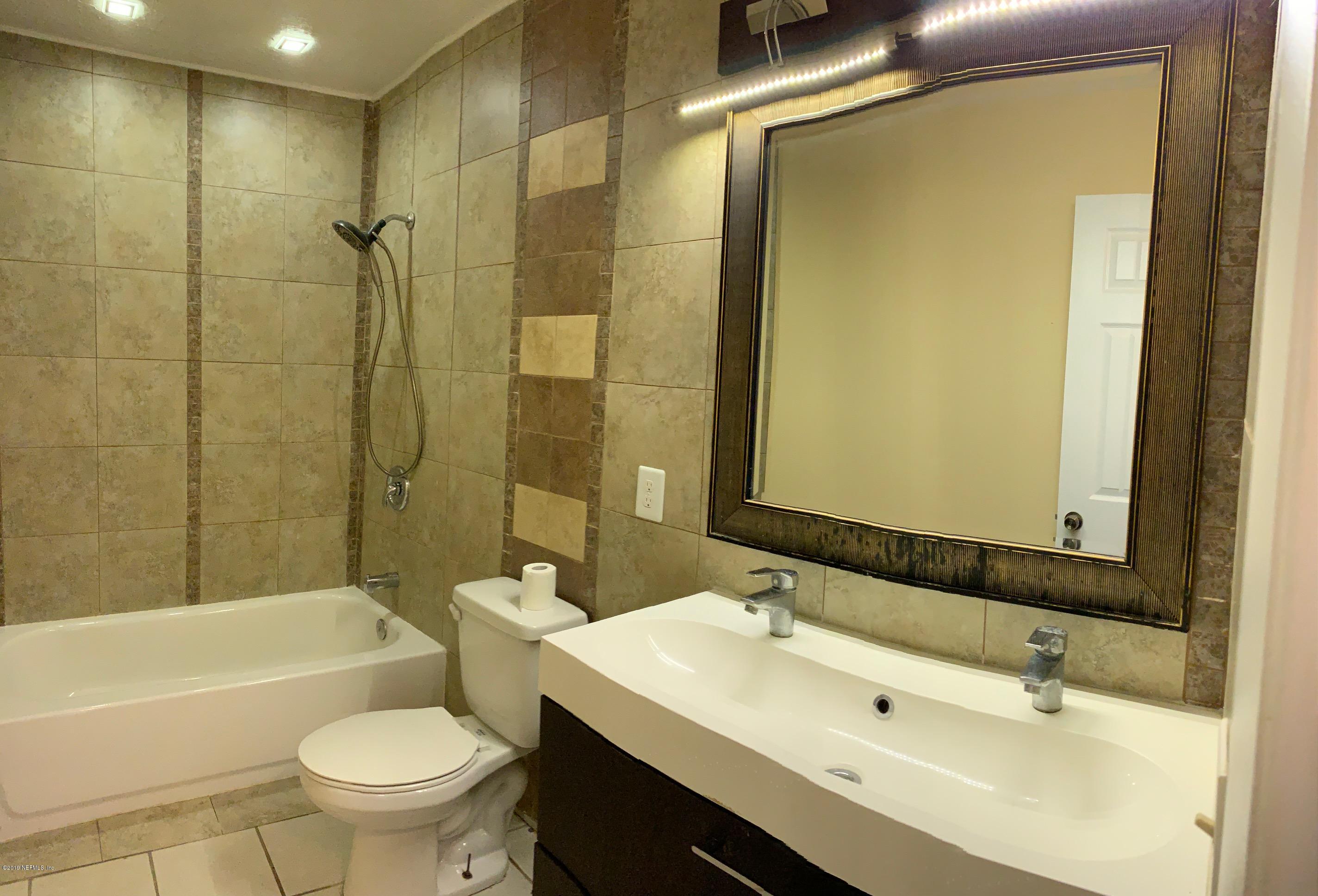 6108 Tuscony Circle Jacksonville, FL 32277 - Photo 9 of 9 a bathroom with a sink mirror toilet and bathtub