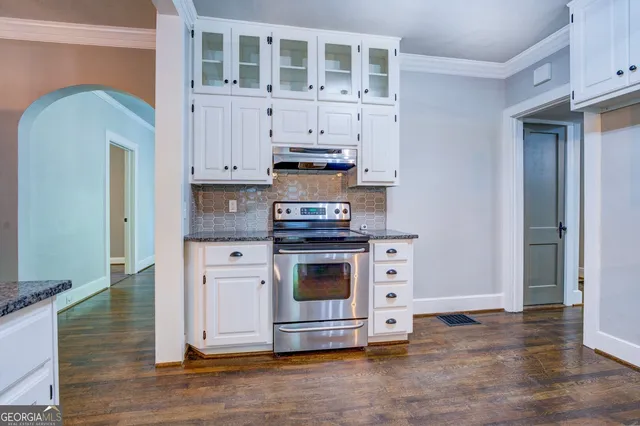a kitchen with stainless steel appliances granite countertop a stove and a refrigerator