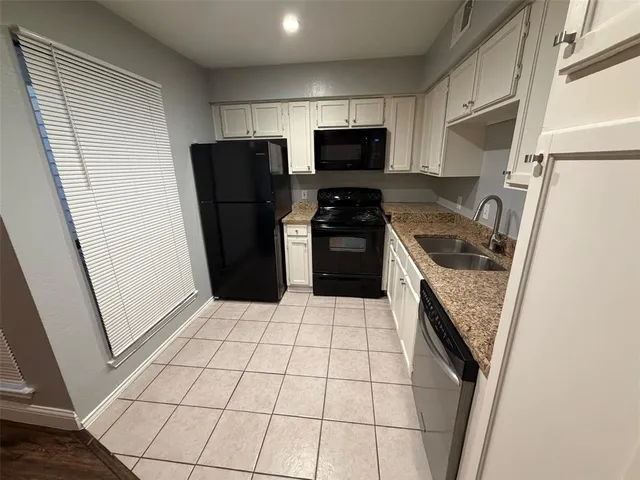 a kitchen with a refrigerator a stove top oven and a counter top space