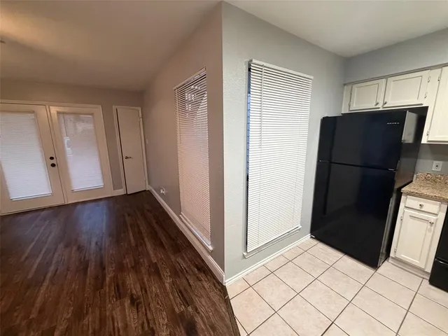 a view of an empty room and wooden floor