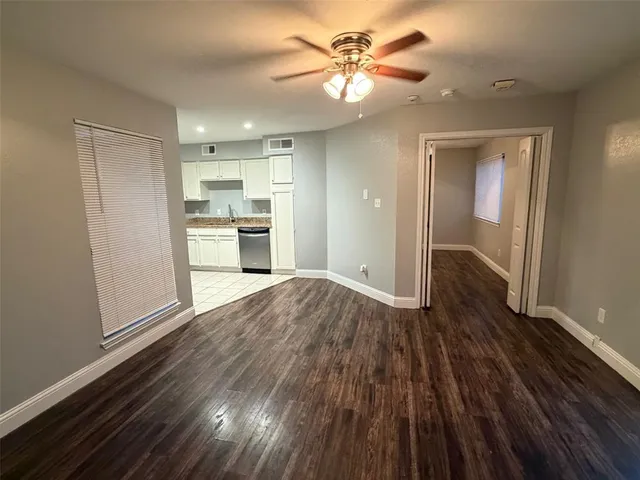 a view of a kitchen with wooden floor and a kitchen