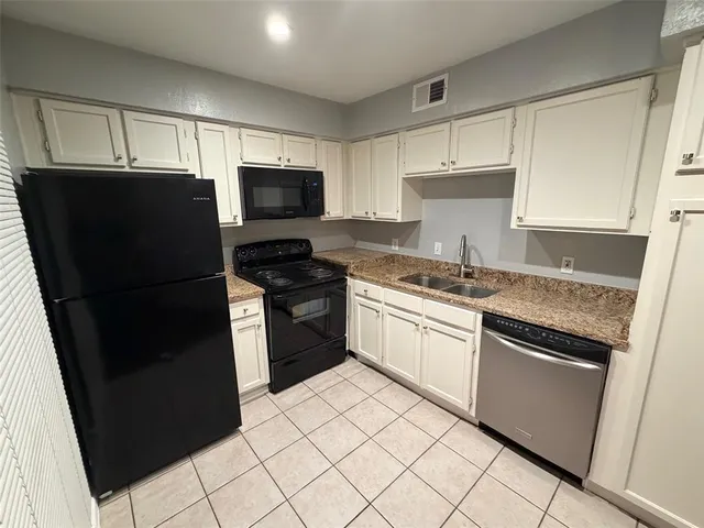 a kitchen with a refrigerator stove and microwave