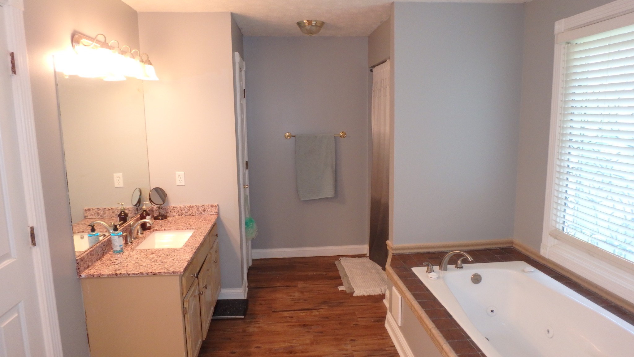 2437 Shop Springs Road Watertown, TN 37184 - Photo 22 of 29 a bathroom with a tub sink and mirror