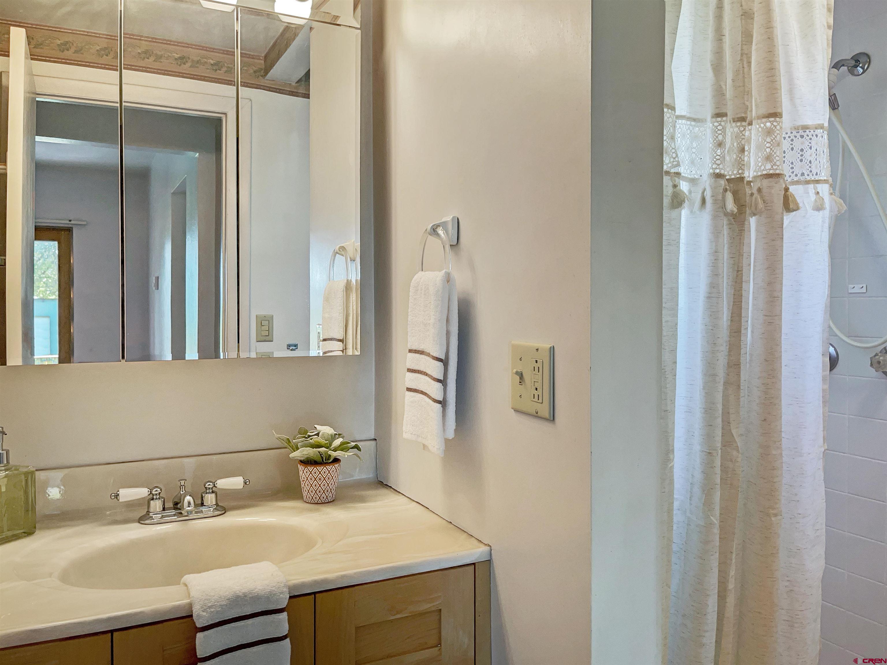 22779 Rd L Cortez, CO 81321 - Photo 8 of 30 a bathroom with a sink and a mirror