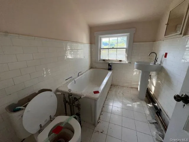 a bathroom with a sink a toilet and bathtub