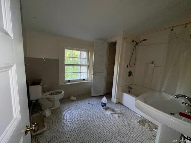 a bath room with a bath tub and a shower