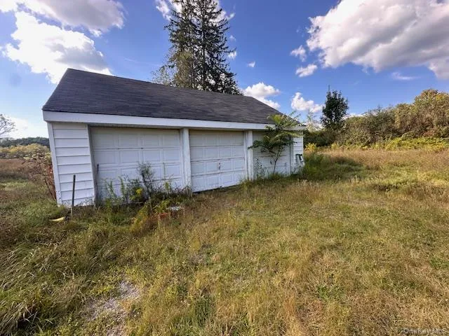 a view of a house with a wooden fence