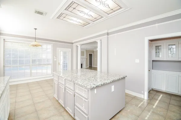 a bathroom with a granite countertop sink a mirror and a shower