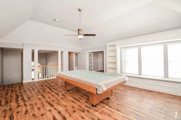 a bedroom with a large bed and a chandelier
