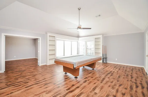 a room with wooden floor and window