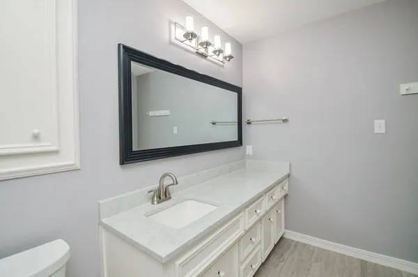 a bathroom with a sink vanity and a mirror