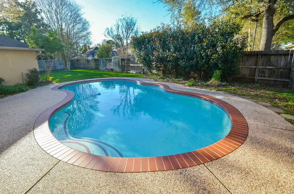 a view of a swimming pool with a yard
