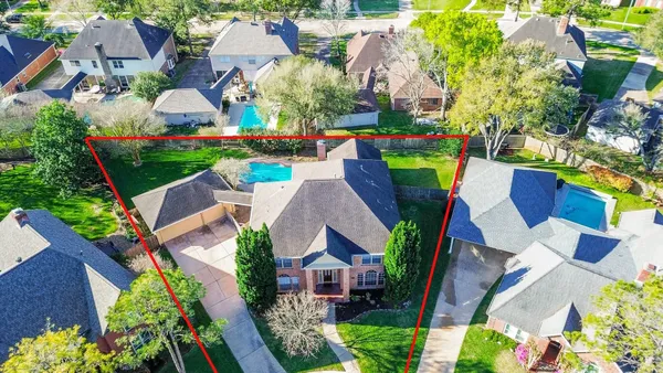 an aerial view of multiple houses with yard